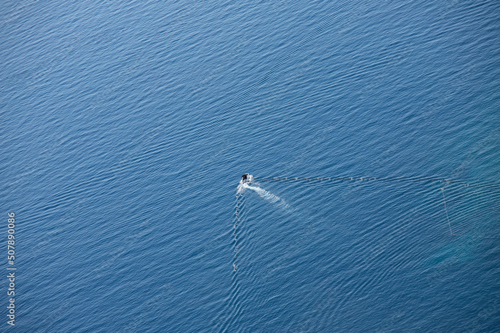 A boat at sea taken from above. Minimalist summer scene from the Adriatic Sea. Vacation, recreation, tourism, Croatia, Dalmatia.