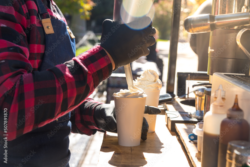 man serving cream to a cafe late in the street, coffee bike, food concept man serving cream to a cafe late in the street, coffee bike, food concept