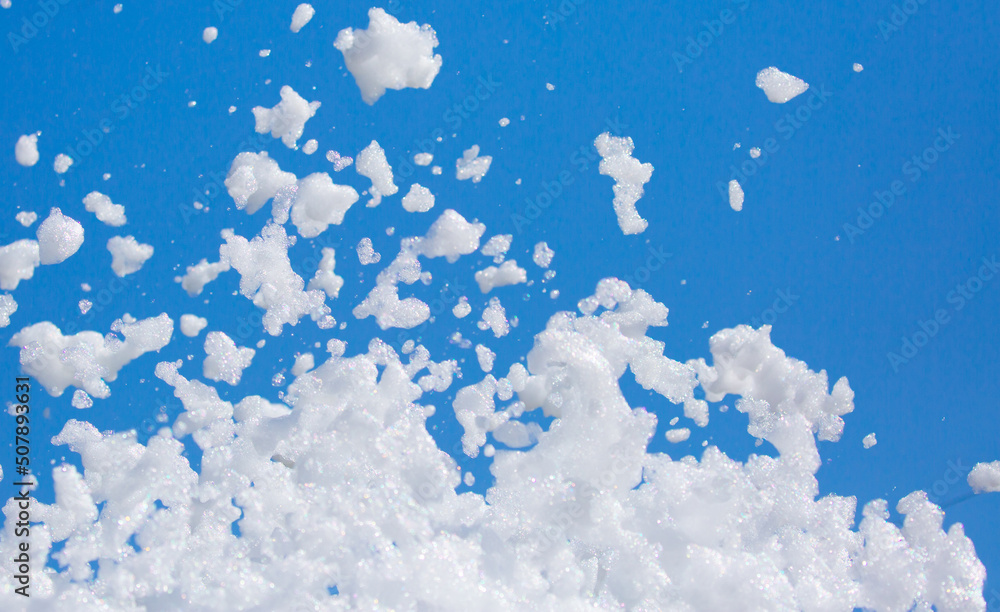 White soap foam on a blue sky background. Fun foam, background or ...
