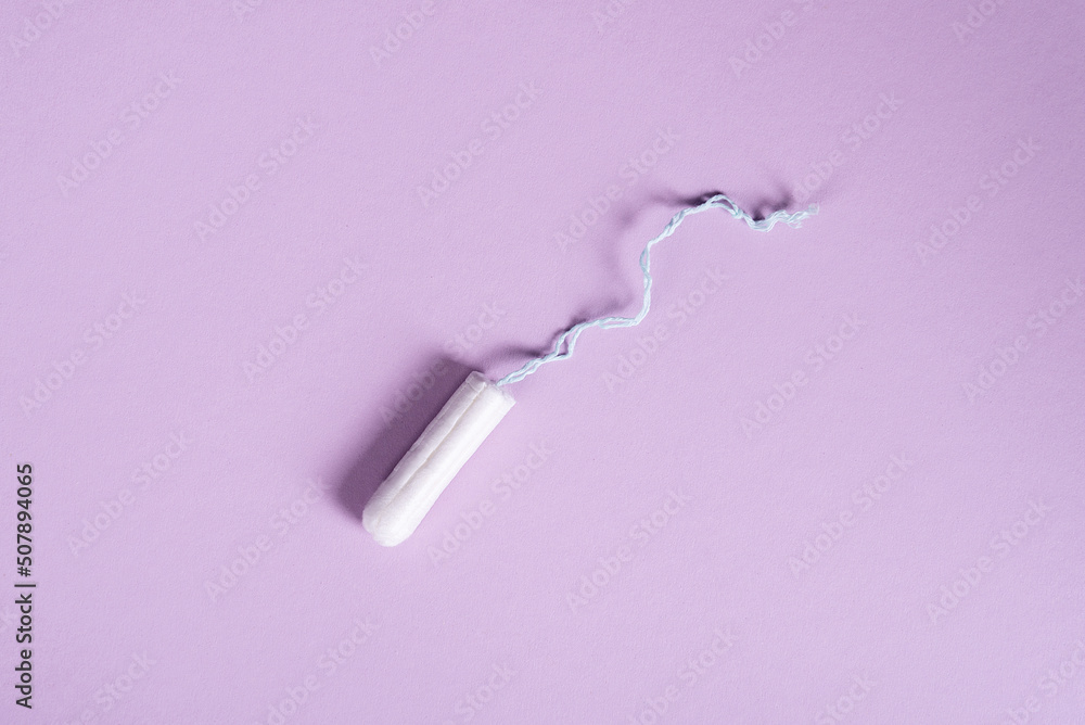 female tampon on a pastel lilac background. flat ley copy space female tampon on a pastel lilac background. flat ley copy space