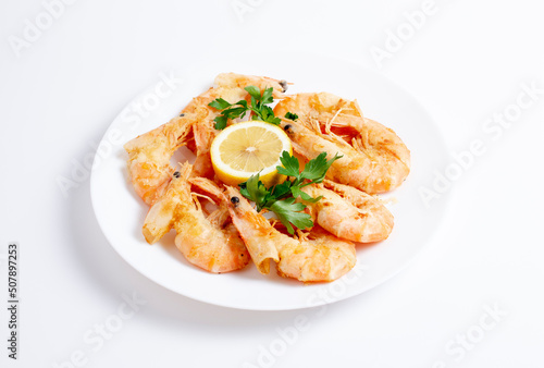Top view of shrimps or prawns on a plate isolated on white background.