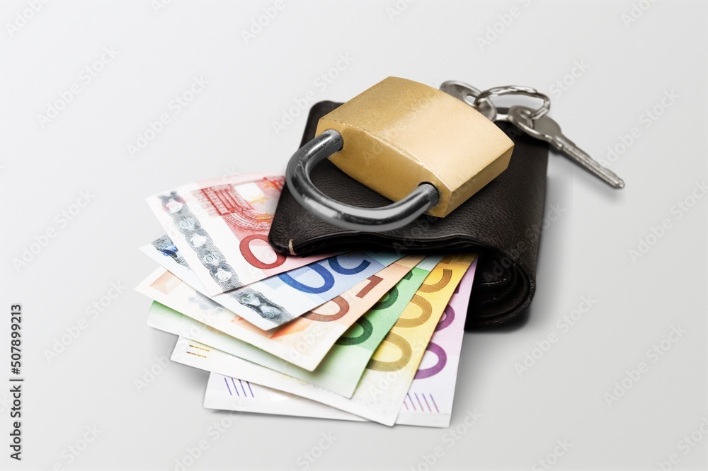 euro banknotes in a chain with a lock on the desk