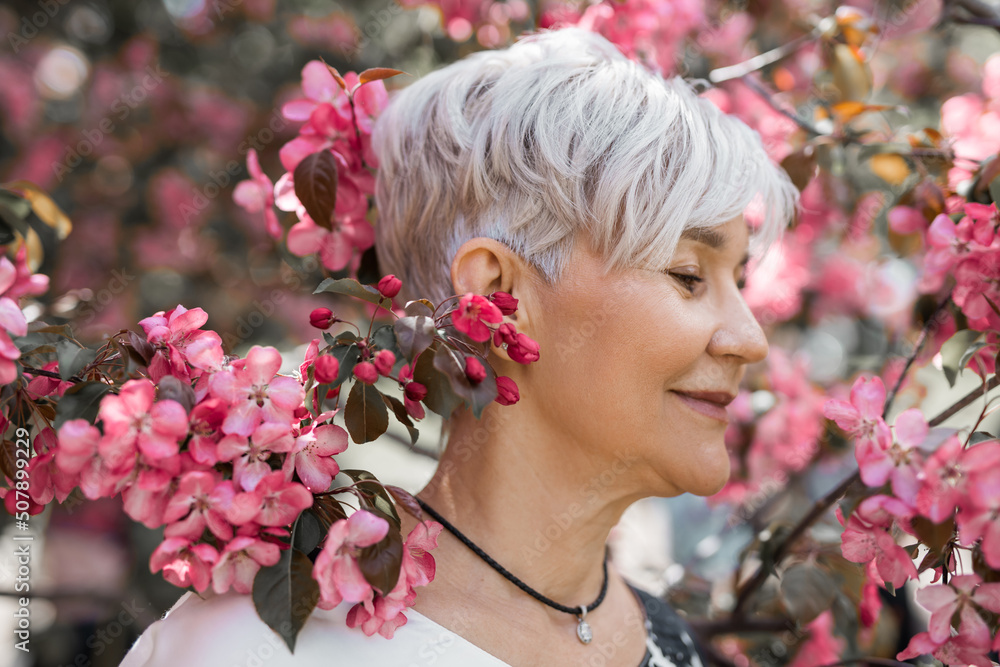 Fototapeta premium portrait of an adult beautiful woman in flowering trees 