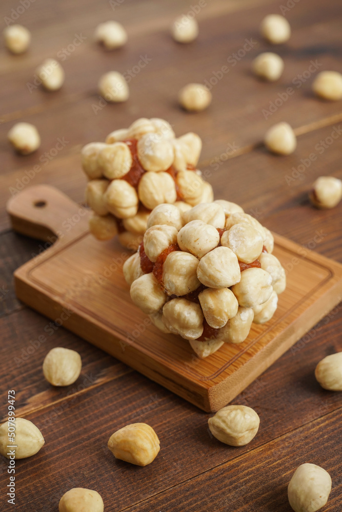 Turkish delights with plenty of hazelnut, pistachio and walnut on a wooden background Turkish delights with plenty of hazelnut, pistachio and walnut on a wooden background