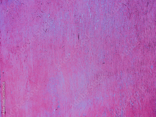 Abstract plywood texture with old magenta paint. photo