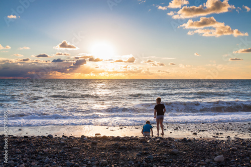 two children boys play on the beach