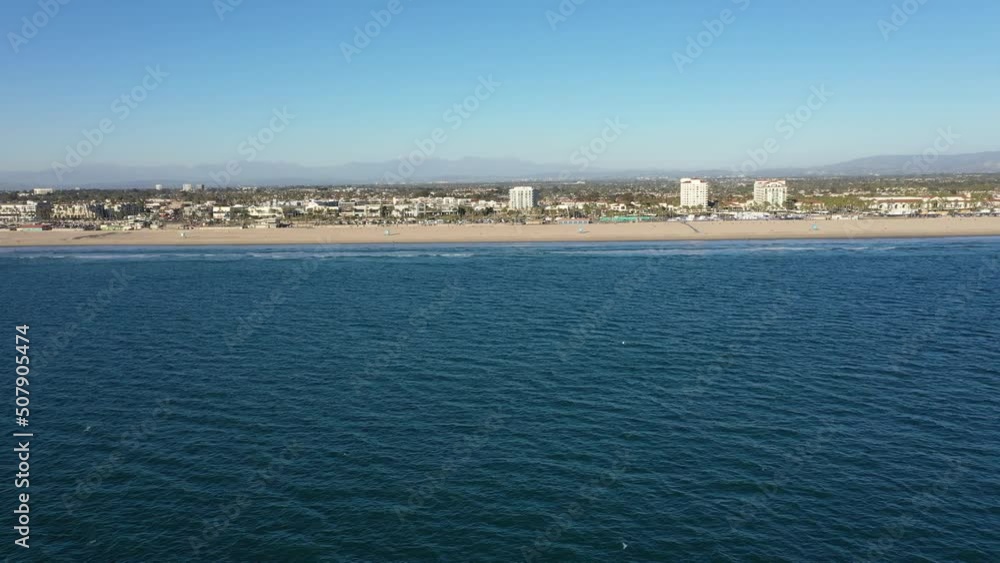 Drone Aerial Over the Pacific Ocean at Huntington Beach California Flying Along Coast Drone Aerial Over the Pacific Ocean at Huntington Beach California Flying Along Coast