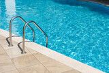 Clear turquoise water in the outdoor swimming pool and railings.