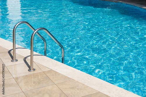 Clear turquoise water in the outdoor swimming pool and railings.