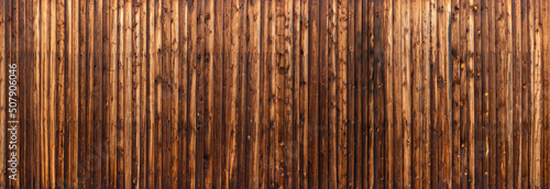 Panorama Holzwand aus genagelten vertikalen Brettern mit abstraktem hell dunkel Muster photo