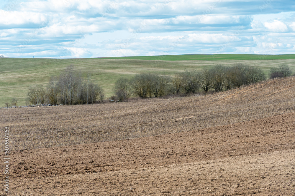 beautiful rural landscape. Hilly plowed agricultural fields against the background of clouds. The play of light and shadow on a hilly landscape. beautiful rural landscape. Hilly plowed agricultural fields against the background of clouds. The play of light and shadow on a hilly landscape.