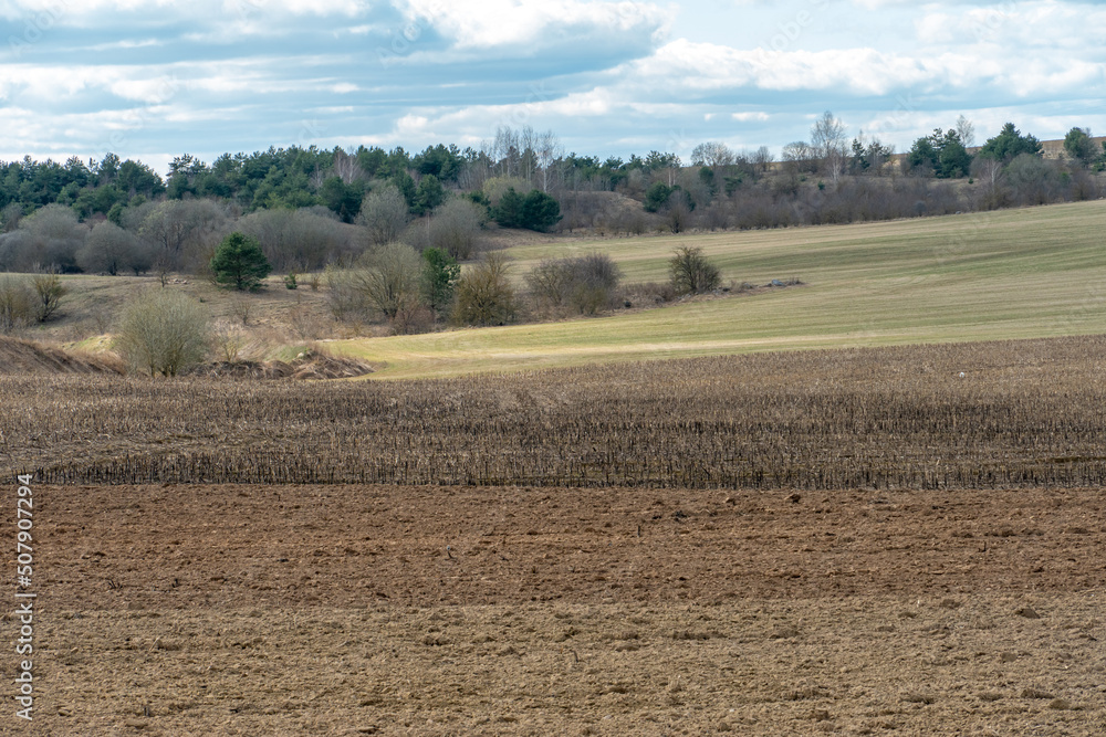 beautiful rural landscape. Hilly plowed agricultural fields against the background of clouds. The play of light and shadow on a hilly landscape. beautiful rural landscape. Hilly plowed agricultural fields against the background of clouds. The play of light and shadow on a hilly landscape.
