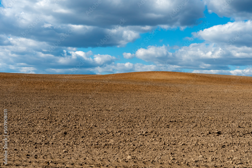 Rows of soil before planting. Drawing of furrows on a plowed field prepared for spring sowing of agricultural crops. View of the land prepared for planting and growing crops. Rows of soil before planting. Drawing of furrows on a plowed field prepared for spring sowing of agricultural crops. View of the land prepared for planting and growing crops.