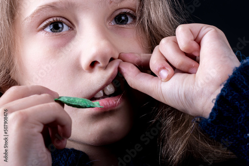 snus. tobacco in bags. a female child uses nicotine. close-up photo