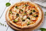 Freshly baked italian pizza with salami, broccoli, cheese on on white background