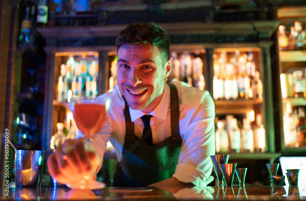 very happy barkeeper serving drink