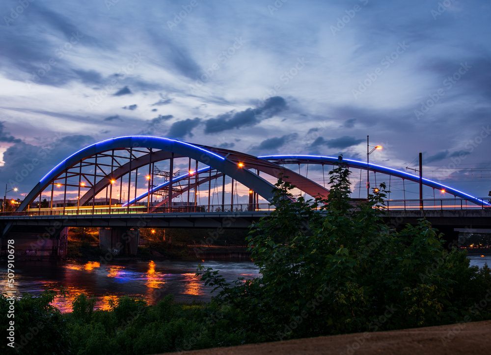 Bridge over River Elbe in Germany at blue hour after summer Sunset with colorful illumination and longtime exposure Bridge over River Elbe in Germany at blue hour after summer Sunset with colorful illumination and longtime exposure