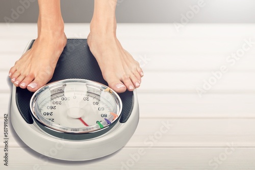 obesity and overweight, overweight woman feet on the scale, obesity and bad habits concept.