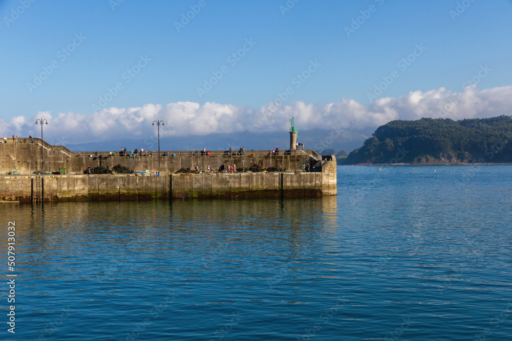 Activity in the dock at the entrance to the port of Lastres in Asturias, Spain 