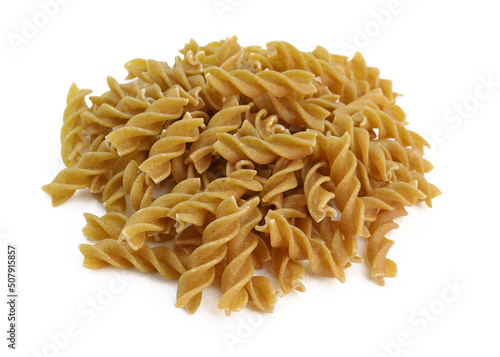 Organic wholemeal rye spiral pasta. Brown durum macaroni on a white background. Heap of raw dry eggless rye fusilli