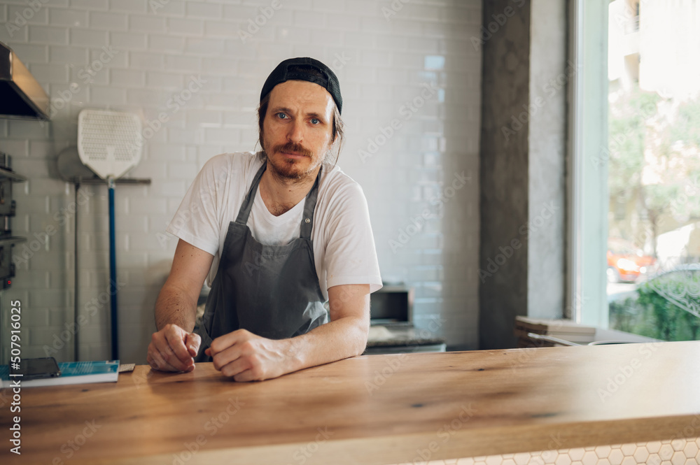 Portrait of a kitchen chef working in a pizza place Portrait of a kitchen chef working in a pizza place