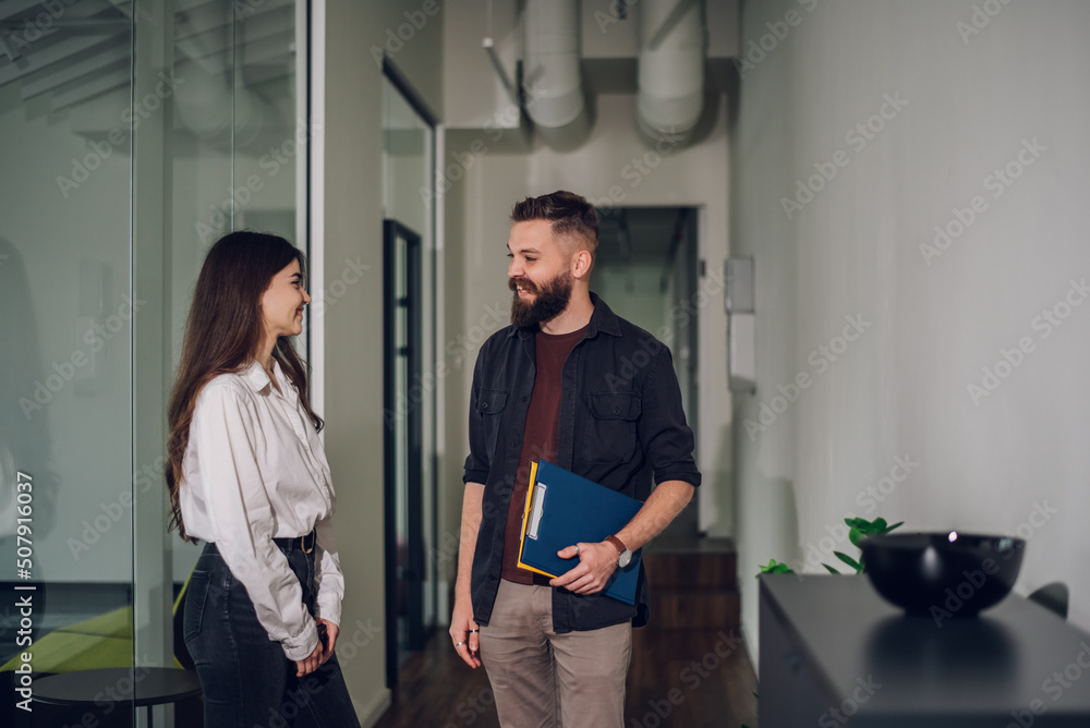 Two business colleagues having a meeting in the open space office Two business colleagues having a meeting in the open space office