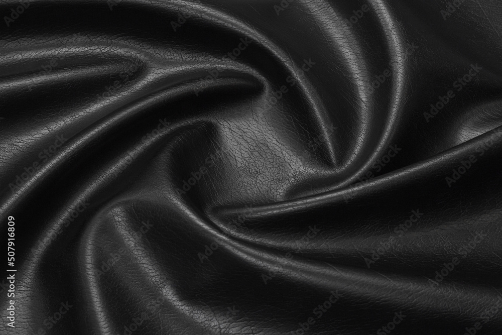 Fototapeta premium black artificial leather with waves and folds on PVC base