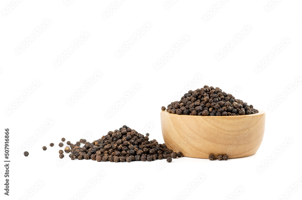 Dried peppercorns are in a wooden cup isolated on white background Dried peppercorns are in a wooden cup isolated on white background
