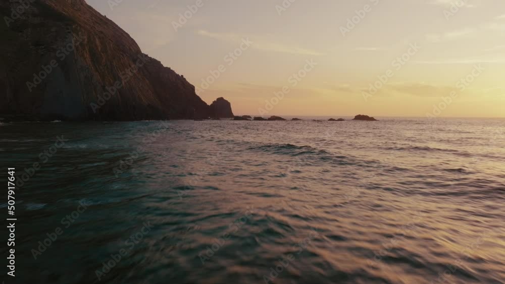 Drone shot very close above water sunset Castelejo waves breaking sunset on Beach Drone shot very close above water sunset Castelejo waves breaking sunset on Beach