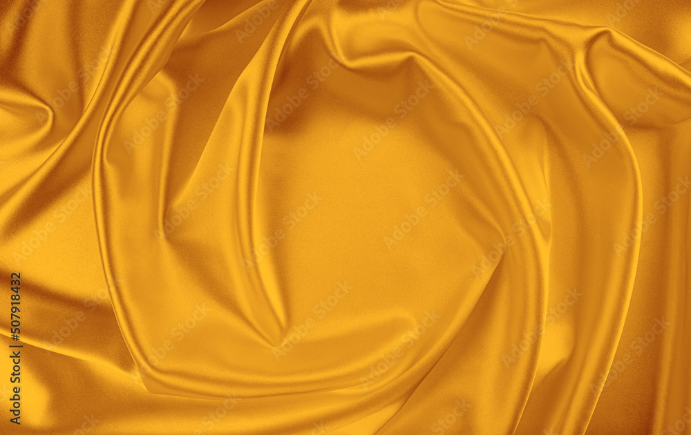 Fototapeta premium Closeup of rippled yellow silk fabric. White silk fabric as an abstract background.