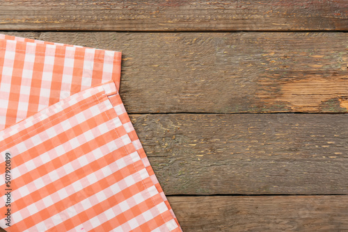 New checkered napkins for picnic on wooden background