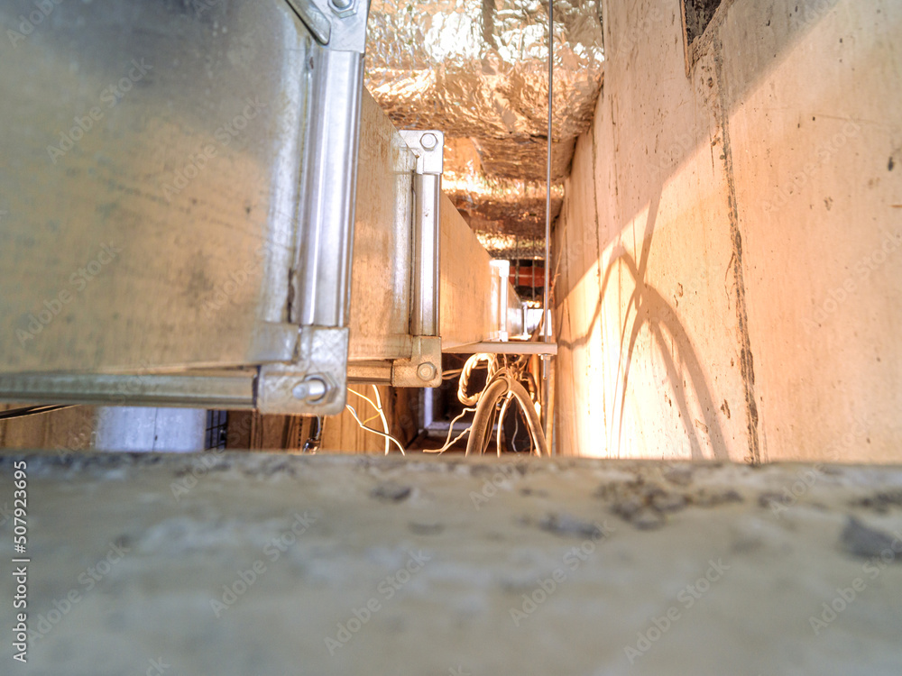 Fototapeta premium ventilation ducts and cable lines with illumination and tinting pass in technological channels of a monolithic building