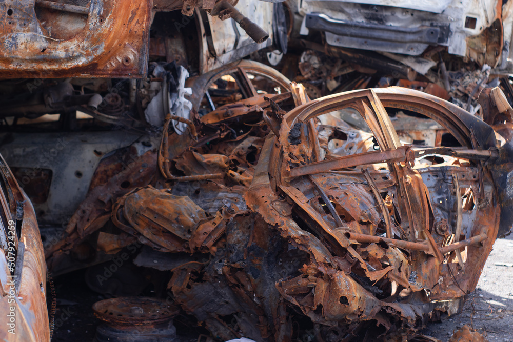 war in ukraine. Car graveyard. Shot cars of civilians. russia's war against Ukraine. Burnt and blown up car. Cars damaged after shelling. irpin bucha. war crimes war in ukraine. Car graveyard. Shot cars of civilians. russia's war against Ukraine. Burnt and blown up car. Cars damaged after shelling. irpin bucha. war crimes