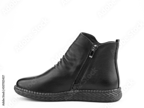 Women's autumn black leather jodhpur boots with black sole isolated on white background. Left side view. Fashion shoes. Photoshoot for shoe shop concept.
