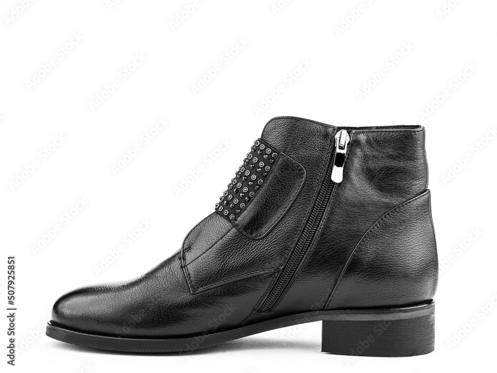 Women's autumn ankle black leather boots with black zip and average heels, isolated white background. Left side view. Fashion shoes. Women's autumn ankle black leather boots with black zip and average heels, isolated white background. Left side view. Fashion shoes.