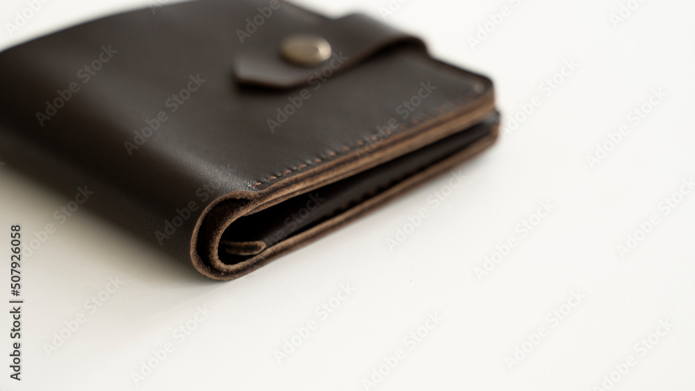 Top view of brown empty man's black handmade genuine leather wallet for banknotes and credit cards isolated on white background. Selective focus, copy space, Close up. Top view of brown empty man's black handmade genuine leather wallet for banknotes and credit cards isolated on white background. Selective focus, copy space, Close up.