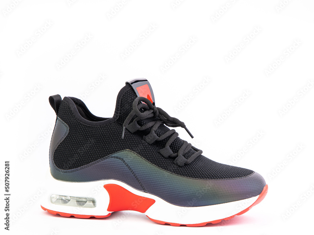 Women's black and orange hiking boots isolated white background. Right side view. Fashion shoes. Photoshoot for shoe shop concept.