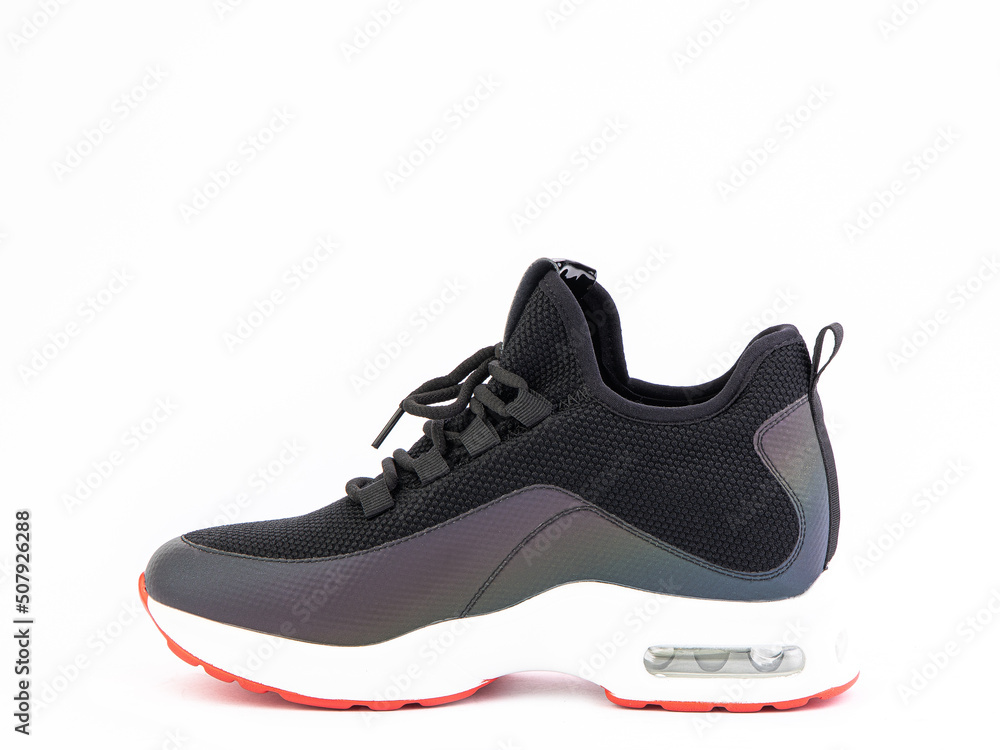 Women's black and orange hiking boots isolated white background. Left side view. Fashion shoes. Photoshoot for shoe shop concept. Women's black and orange hiking boots isolated white background. Left side view. Fashion shoes. Photoshoot for shoe shop concept.