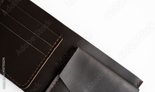 Fotografie Top view of open brown empty man's black handmade genuine leather wallet with pockets for banknotes, credit cards and monets isolated on white background