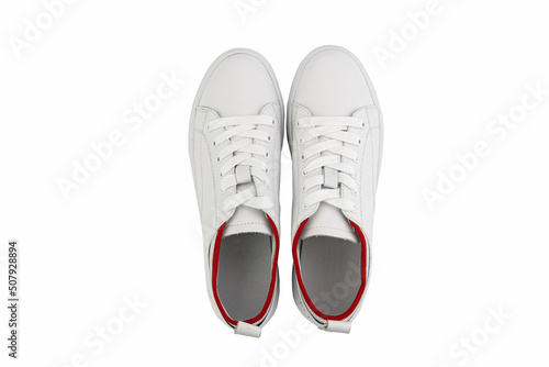Obraz na płótnie White leather sneakers. Casual women's style. White lacing and white rubber soles. Isolated close-up on white background. Top view. Fashion shoes w salonie