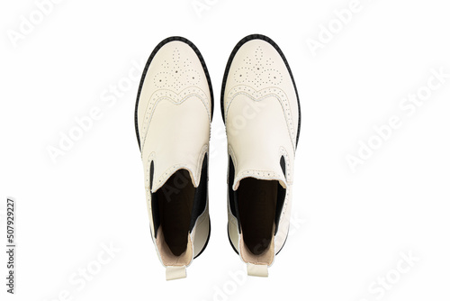 White leather chelsea boots. Isolated close-up on white background. Top view. Fashion shoes.