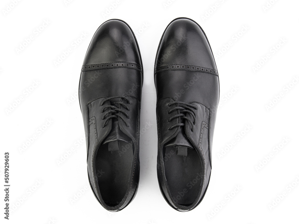 A pair of classic leather elegant men's shoes isolated white background. Groom's stylish black shoes. Isolated object close up on white background. A pair of classic leather elegant men's shoes isolated white background. Groom's stylish black shoes. Isolated object close up on white background.