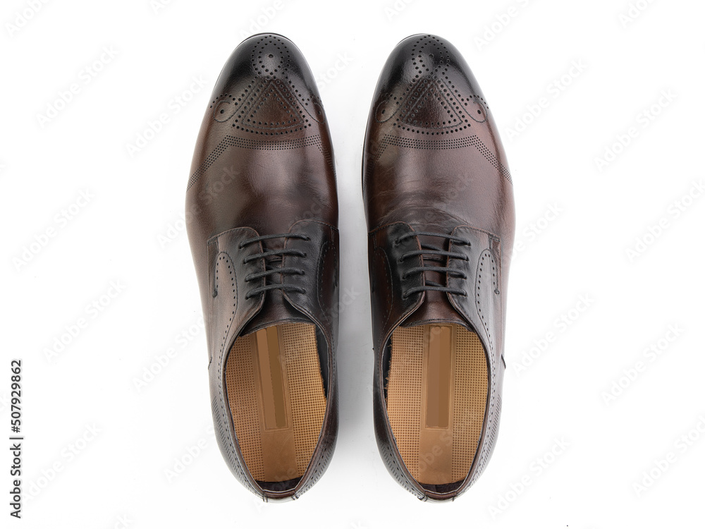 A pair of classic leather elegant men's shoes isolated white background. Groom's stylish black shoes. Isolated object close up on white background.