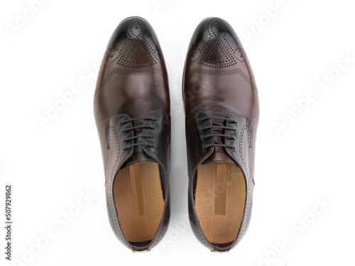 A pair of classic leather elegant men's shoes isolated white background. Groom's stylish black shoes. Isolated object close up on white background.