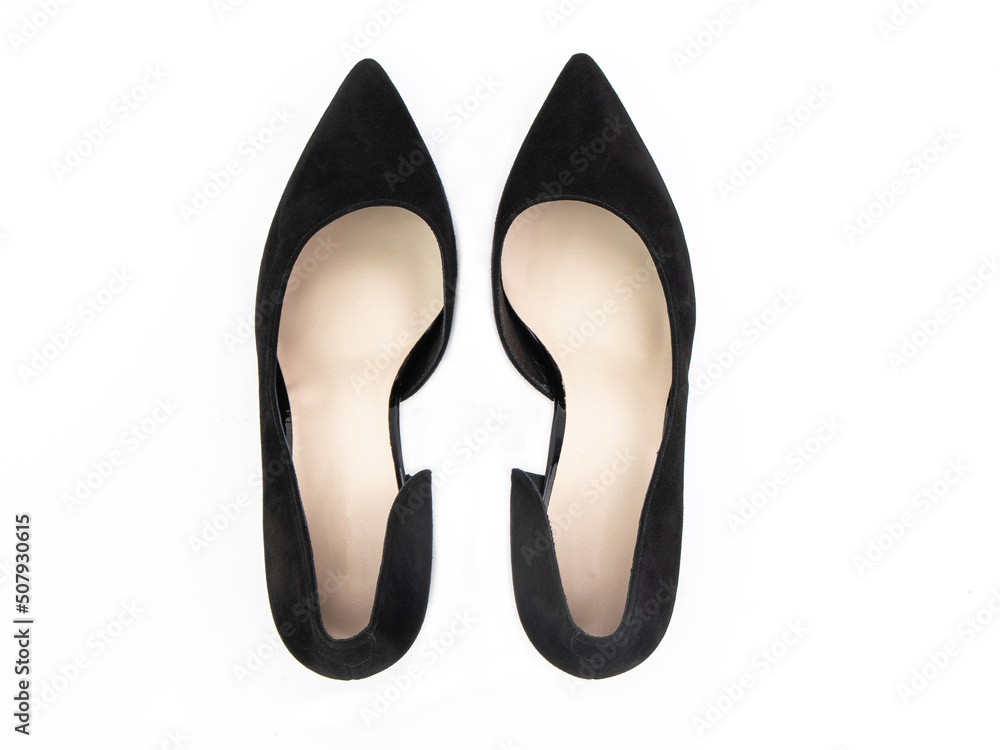 Classic and elegant high-heeled women shoes. Stylish black shoes on high thin heels and with a pointed toe. Isolated object close up on white background. Top view.