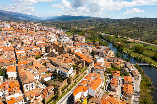 Bird's eye view of residential buildings with tiled roofs, Jerte River and cathedral in Plasencia, Extremadura, Spain.