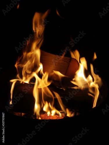 logs in a firepit close up detailed flames night time 