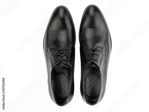 A pair of classic leather elegant men's shoes isolated white background. Groom's stylish black shoes. Isolated object close up on white background.