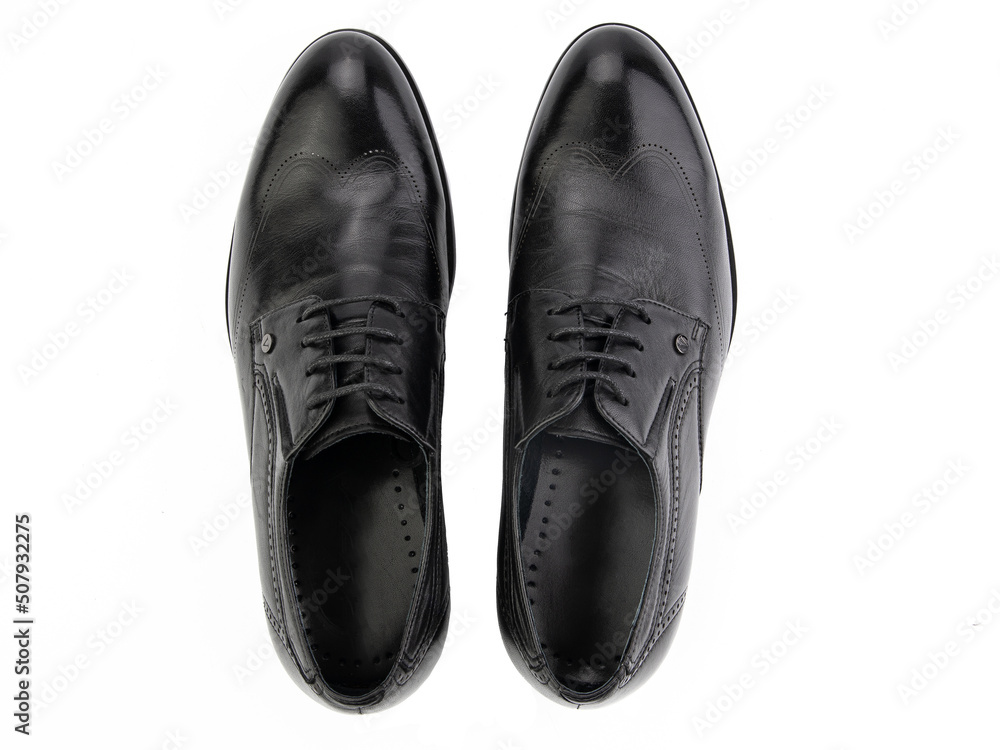 A pair of classic leather elegant men's shoes isolated white background. Groom's stylish black shoes. Isolated object close up on white background.