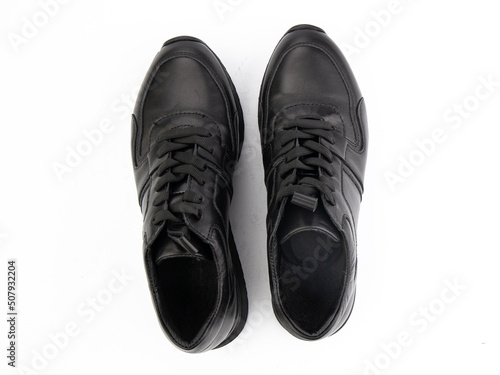 Obraz na płótnie A pair of classic leather elegant men's shoes isolated white background. Groom's stylish black shoes. Isolated object close up on white background. w salonie